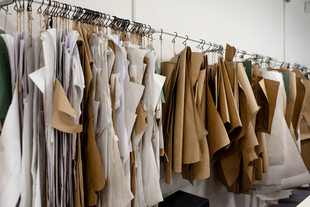 Assorted sewing patterns on hangers inside tailor atelier